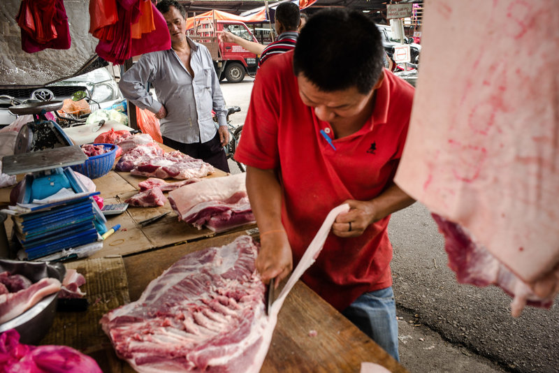  A butcher prepares cuts of meat for customers at a market in Klang. Between 1970 and the late 1990s, Malaysia's pork industry exploded. The pig population tripled to more than 3 million. After the government killed 1 million pigs, the industry nearly collapsed. Sanjit Das for NPR 