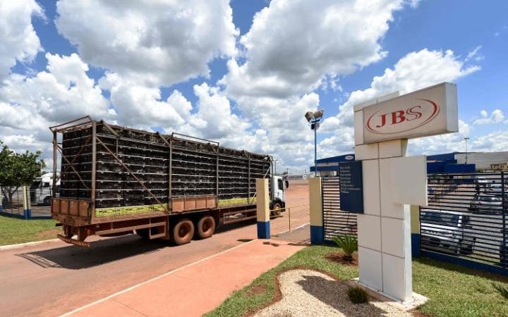  A truck loaded with chickens arrives at JBS-Friboi chicken processing plant, in Samambaia, Brazil Credit: AFP 