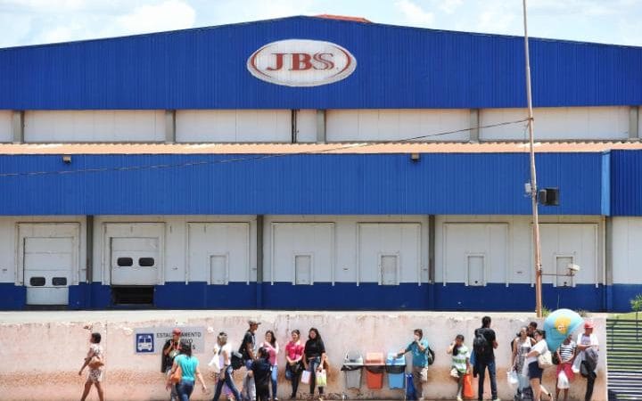  Workers are pictured outside the JBS-Friboi chicken processing plant in Samambaia Credit: AFP 