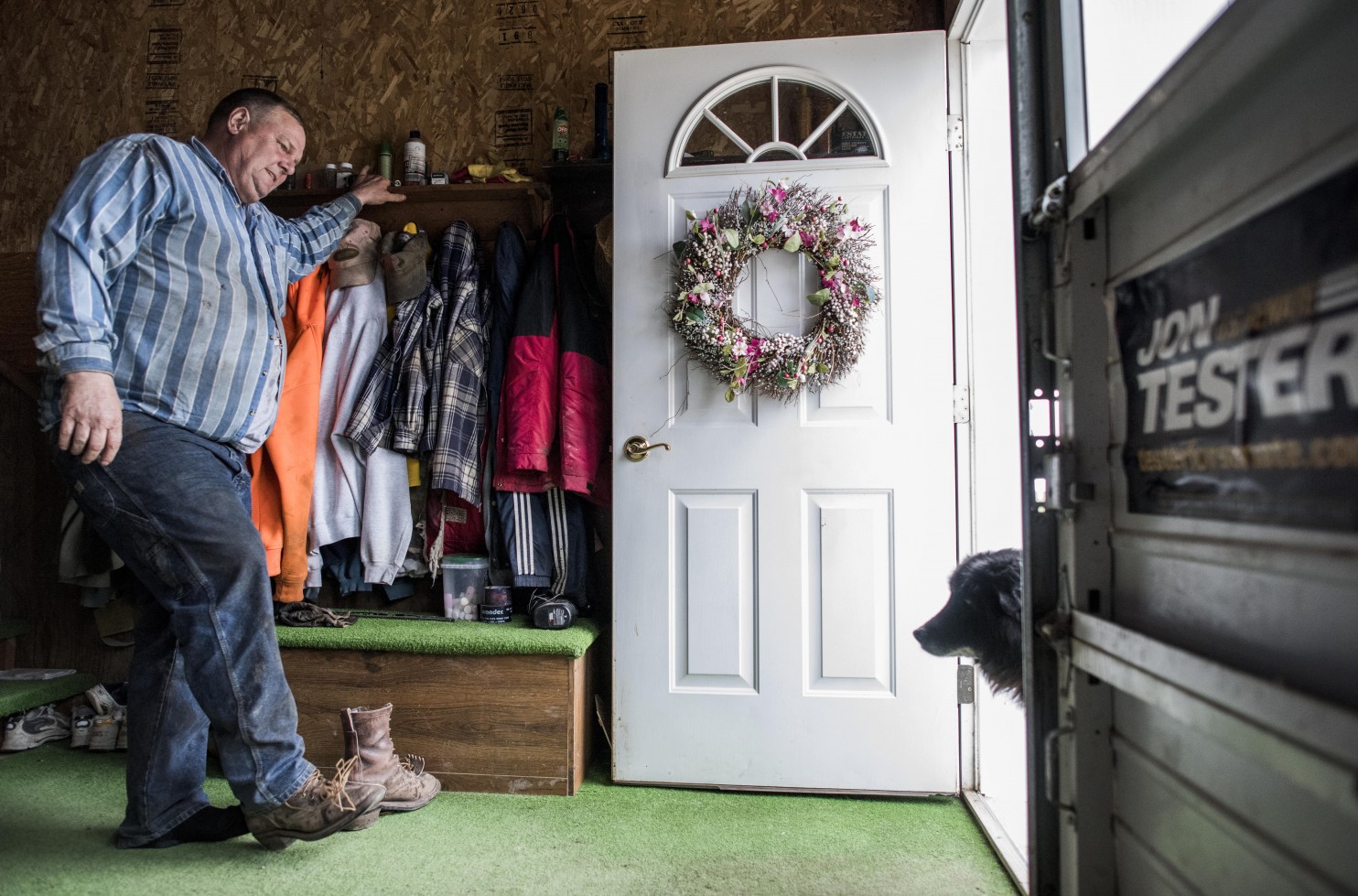 After long day of farm work, Sen. Jon Tester removes his dirty boots in the garage on his Montana farm. As a red-state Democrat, he offer useful insights for his party — but faces a tough 2018 race. (Melina Mara/The Washington Post)